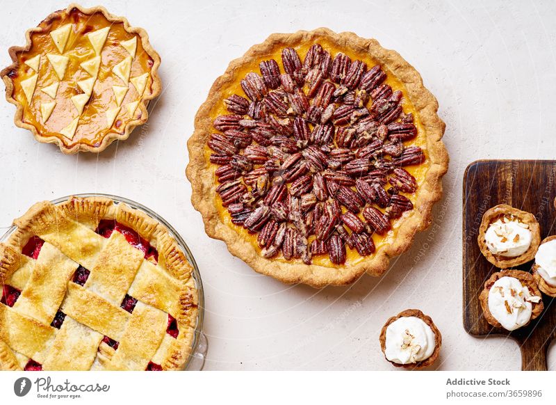 Top view of variety of thanksgiving pies food pecan apple pumpkin season autumn baking dinner seasonal round traditional closeup fresh cuisine table festive