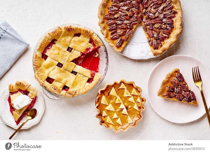 Top view shot of variety of thanksgiving pies food pecan apple pumpkin season autumn baking dinner seasonal round traditional closeup fresh cuisine table