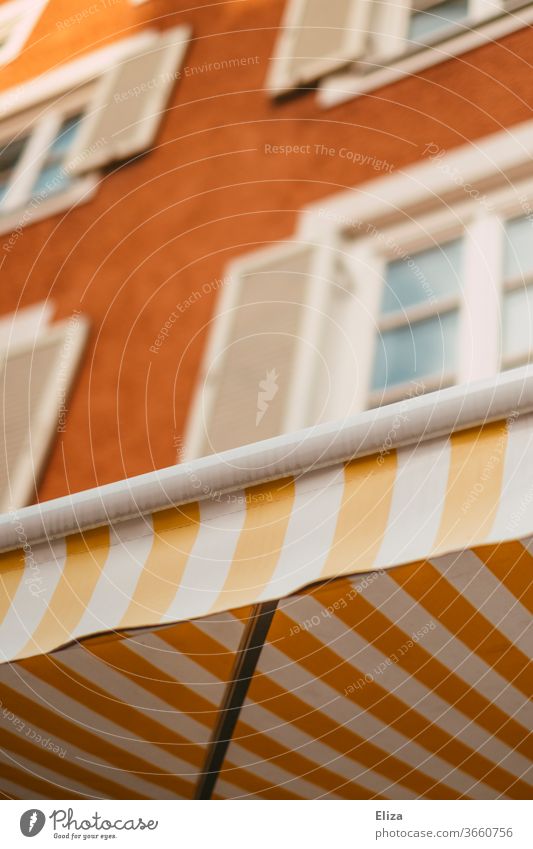 Yellow and white striped awning on a pretty facade Sun blind White Striped Facade kind Old building Window built House (Residential Structure) Old town