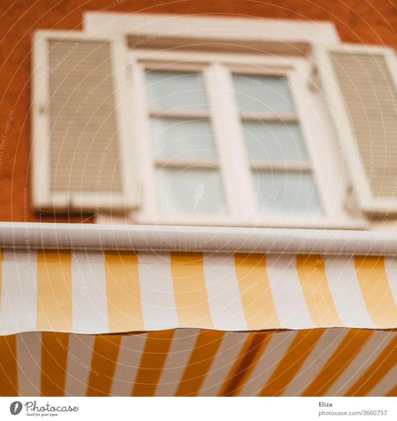 Yellow and white striped awning on a pretty facade Sun blind White Striped Facade kind Old building Window built House (Residential Structure) Old town