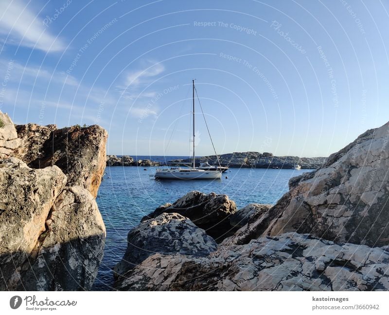 Sailboat mooring in calm bay surrounded by rocks sailing boat Sailing Water vacation travel Freedom Summer Sailing ship Vacation & Travel Ocean Adventure sea