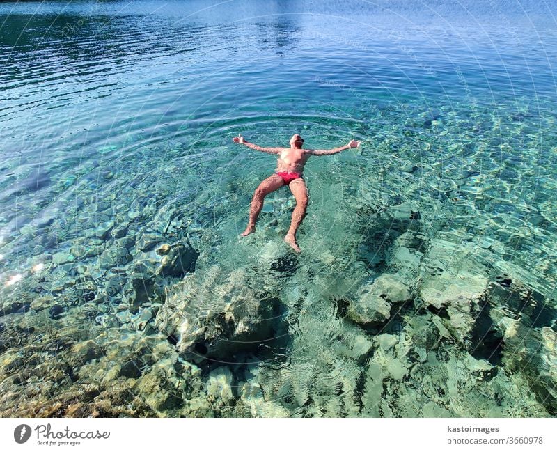 Man relaxing on vacation, floating in calm tourquoise sea. Float in the water Ocean Summer Swimming & Bathing Vacation & Travel Beach Tourism Turquoise Bay