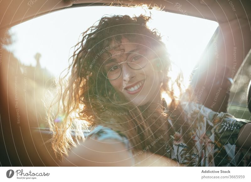 Happy woman inside car sunshine cheerful toothy smile happy joy positive weekend feminine eyeglasses charming enjoy glad casual wear female summer eyewear