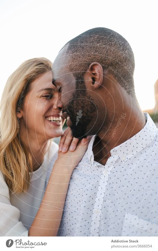 Tender multiracial couple hugging each other lovingly bonding rest in love romantic content tender sensual eyes closed cuddle happy cheerful fondness affection