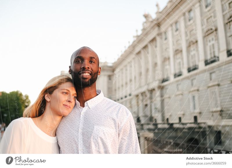 Tender multiracial couple hugging each other lovingly bonding rest in love romantic content tender sensual cuddle happy cheerful fondness affection relax