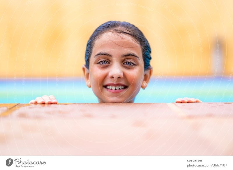 Little girl into the water on a pool´s edge active activity adorable beauty caucasian child childhood colorful cute day enjoyment face fun funny happiness happy