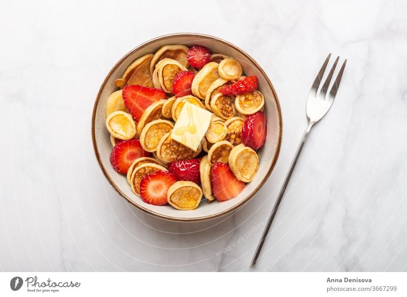 Tiny cereal pancakes and strawberries mini pancakes strawberry breakfast buttter homemade snack tasty sweet food delicious honey syrup tiny trendy food bowl