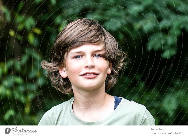 ah, a haircut is overrated.... Cool (slang) Brash long hairs Colour photo Family Light Day Face Infancy Boy (child) Child Close-up Contrast portrait Sunlight