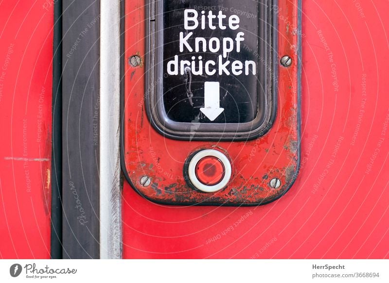 Tram door - "Please press button" push button Pressure button press Key open Characters invitation Arrow Mechanism Signage Red Letters (alphabet) Public transit