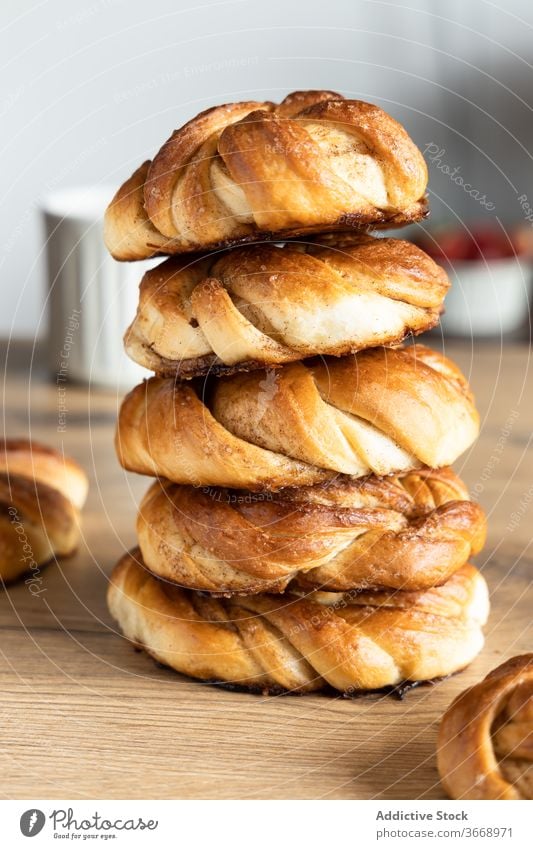 Pile of delicious cinnamon buns on table roll pile tasty kitchen morning breakfast homemade coffee cup wooden food stack fresh drink yummy gourmet hot tradition