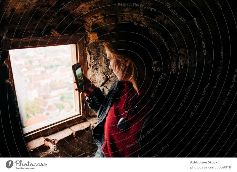 Traveling woman taking photo on smartphone during vacation take photo cityscape travel tourist shabby building using female transylvania romania saint george