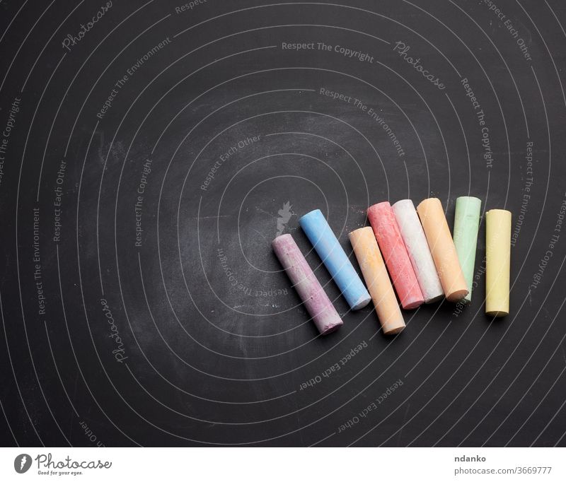 multicolored chalk on lie on empty black chalk board stick clean piece ad advertisement art background billboard blackboard blank chalkboard class classroom