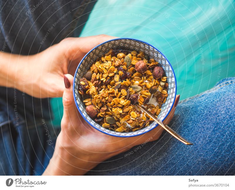 Girl in jeans eating home made granola bowl homemade pumpkin squash girl woman pie lifestyle top view thanksgiving autumn fall seasonal above breakfast muesli