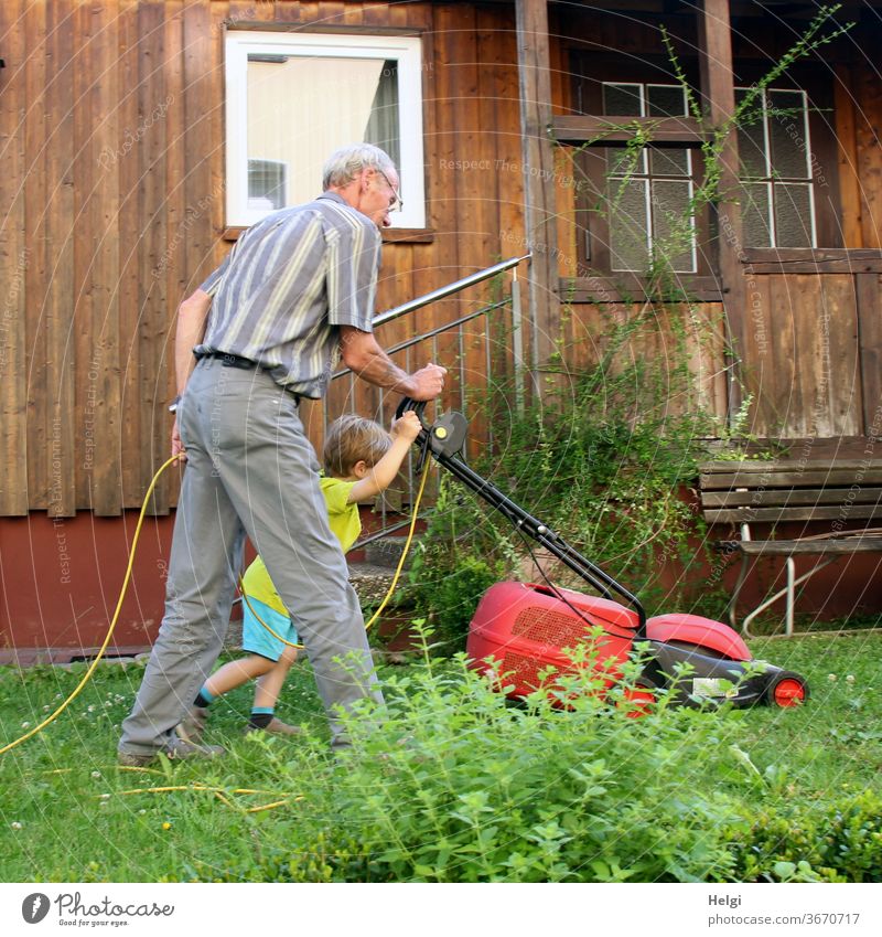 it works better together - grandpa and grandchildren mow the lawn in the garden | favourite person(s) Human being Senior citizen Child Toddler Man Grandfather