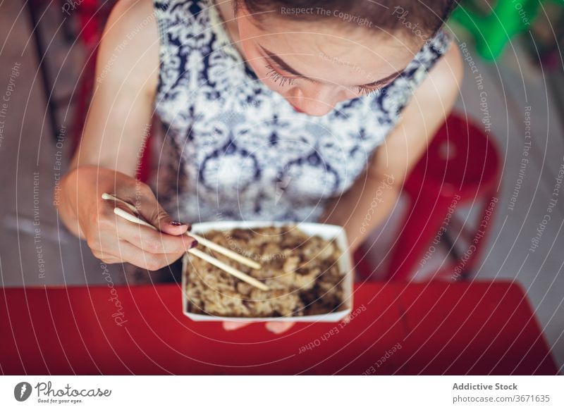 Crop Asian woman eating rice in Zhubei Night Market glutinous oil rice dish oriental zhubei night market delicious tradition street food chopstick female taiwan