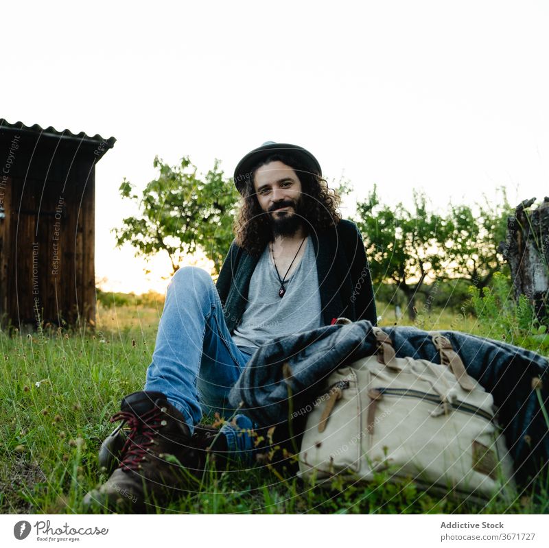 Smiling traveling man looking at camera hipster traveler portrait vacation tourist content beard smile style male nature carefree cheerful enjoy relax happy