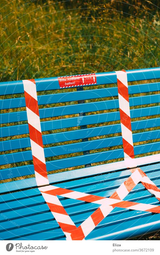 A bench with distance markings gap Bench Parbank Sit keep sb./sth. apart social distancing Measure Blue out Nature barrier tape forbidden corona covid-19