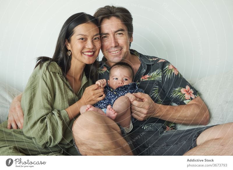 Parents sitting with their son enjoying the time together at home family baby child boy dad father mom mother fun stay at home beautiful model portrait flat