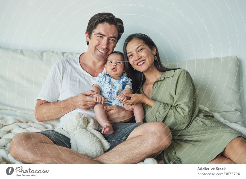 Parents sitting with their son enjoying the time together at home family baby child boy dad father mom mother fun stay at home beautiful model portrait flat