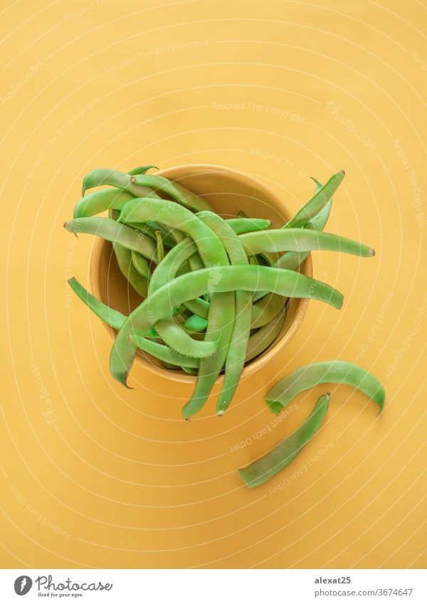 Green beans in a bowl on yellow background with copy space agriculture cuisine diet food fresh freshness green green bean group healthy ingredient legume long