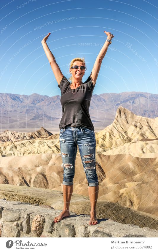 Happy caucasian woman standing at the Zabriskie Point, Death Vallkey National Park point zabriskie happiness visitor landscape travel desert nature california