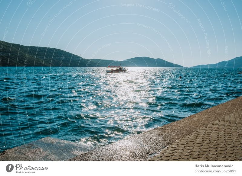 boat sailing in the distance on the sea background beach beautiful blue coast concept europe holiday island landscape mediterranean nature ocean outdoor relax