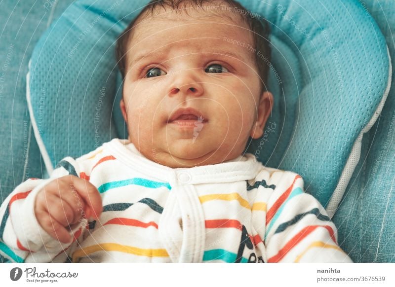 Surprised newborn girl while relax in her hammock baby surprise curious wow look cute adorable family comfort pajama face pretty lovely caucasian blue eyes