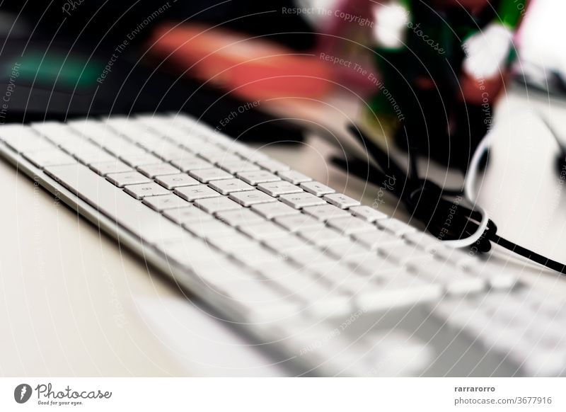 a modern gray computer keyboard with white keys on an office table. technology business button letter equipment closeup alphabet electronic internet background