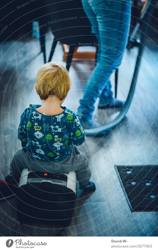 little boy rides on a vacuum cleaner while mommy vacuums Child Toddler occupational therapy Employment creatively Infancy fun do the cleaning help Parenting Joy