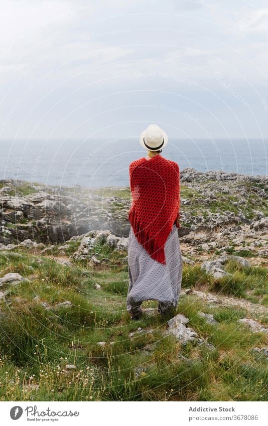 Travelling woman enjoying seascape near geyser coast travel admire nature freedom relax jesters of arenillas spain asturias llanes female style gesture stone