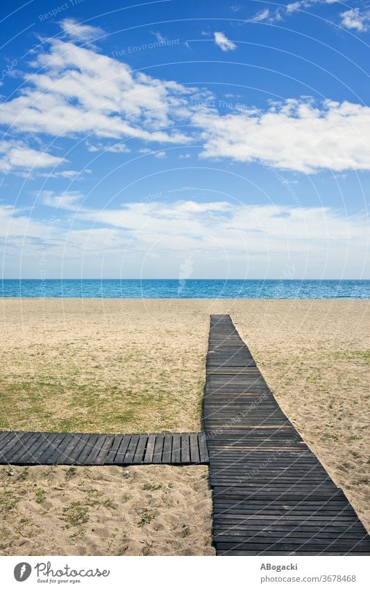 Beach with wooden boardwalk on Costa del Sol in Marbella, Spain beach sea ocean marbella spain vacation nature shore sandy mediterranean copyspace horizon water