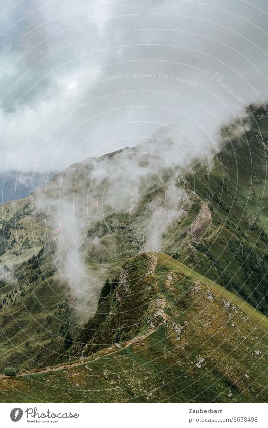 Hiking on a ridge path from the Rosskopf to the Ochsenscharte, mountains, meadows and clouds off Ridgeway Clouds Fog hillside Steep Mysterious Alps Stubai Alps