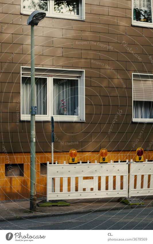 construction site Construction site House (Residential Structure) Street streetlamp cordon Gloomy Brown Yellow Window Facade Deserted