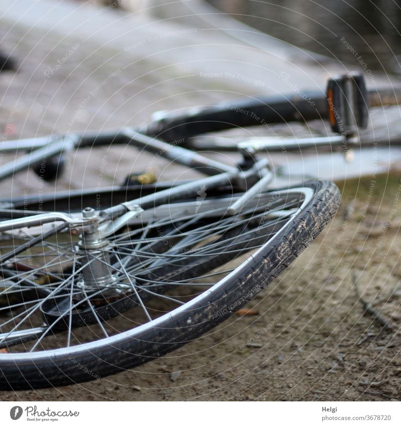 bent - old bicycle with bent wheel lies on the ground Bicycle Wheel Broken warped Exterior shot Transport Town Means of transport Vehicle Accident Old Cycling