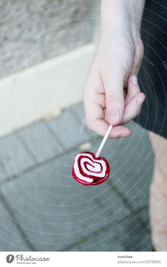 hand holding a lolly Lolly lollipop by hand Youth (Young adults) teenager Child Lick candy Sugar Infancy Sweet Xylitol tooth-friendly Dentist Candy Delicious