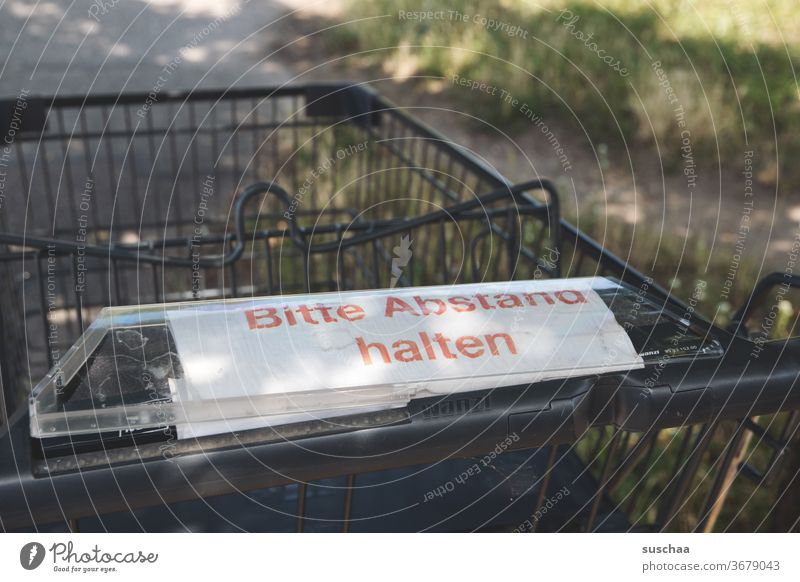 shopping cart marked "please keep your distance" Shopping Shopping Trolley Inscription gap Warn invitation Corona virus Protection keep sb./sth. apart pandemic