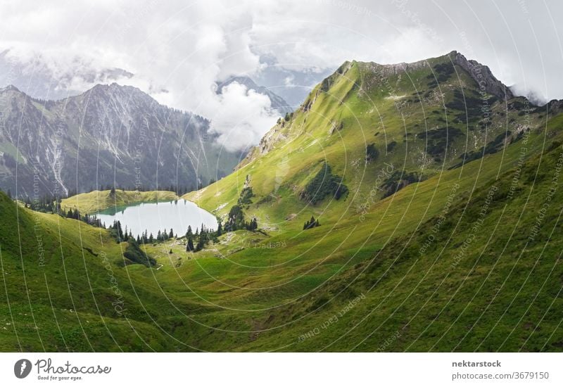 Alp Mountain Lake and Green Valley lake mountain beauty in nature Alps meadow idyllic green grass scenic clouds no people nobody nature photography day