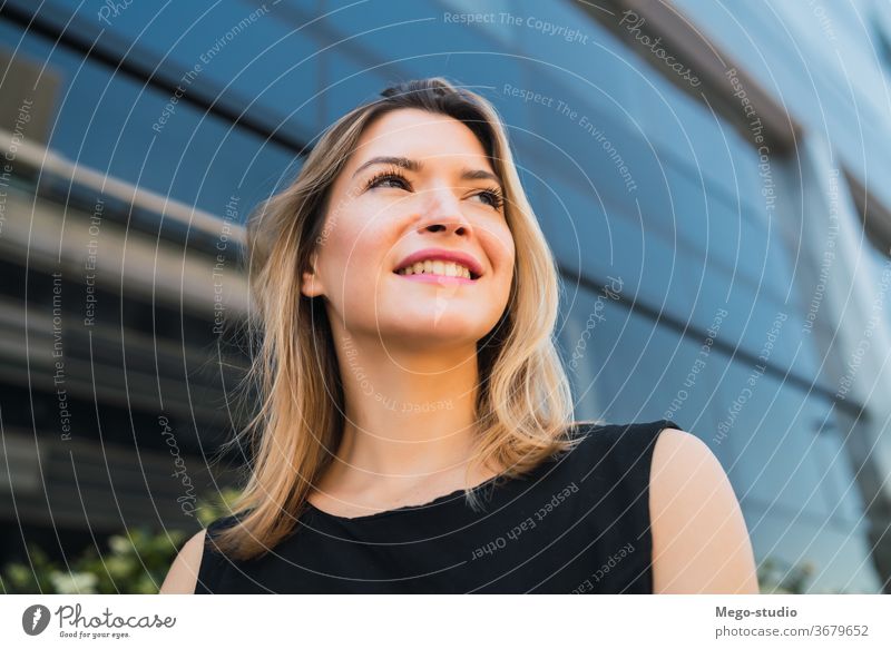 Business woman standing outside office buildings. portrait businesswoman professional young businesspeople corporate manager note career looking attractive hold