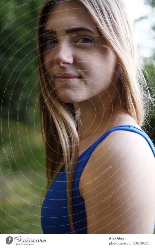 Lateral portrait of a young woman in a blue summer dress in the nature Purity luck Beautiful weather Trip Expectation Sunlight Close-up Day