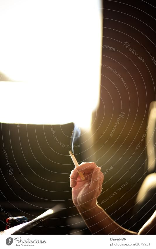 Woman holds a smoking cigarette in her hand Cigarette smoke steam Smoking Smoky Smoker Anonymous Deep depth of field Sunlight Sunbeam Yellow Addiction Nicotine