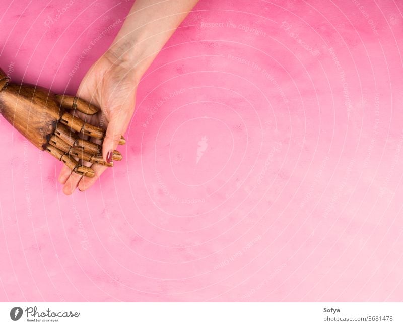 White female hand holding black wooden hand community together social diversity diverse flat lay equality background love caucasian family person woman