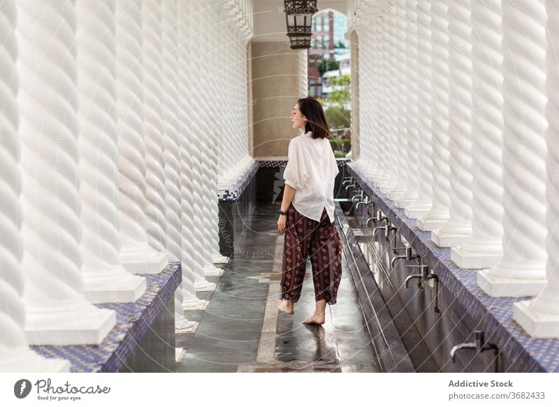 Asian woman in arched passage of Omar Ali Saifuddien Mosque omar ali saifuddien mosque travel landmark tourist city female asian ethnic bandar seri begawan