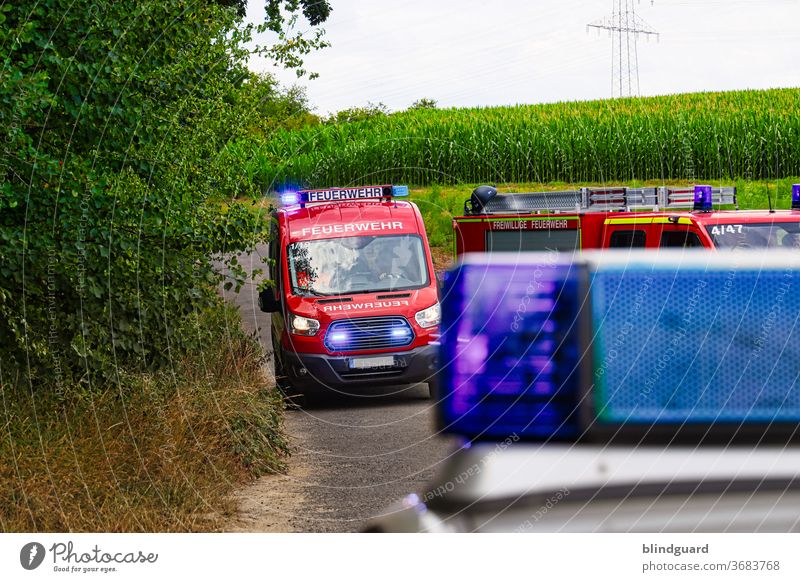 Place your bets... Fire brigade on its way to the scene, the access road is secured by the police. Police out of focus. Fire department Deployment Police Force