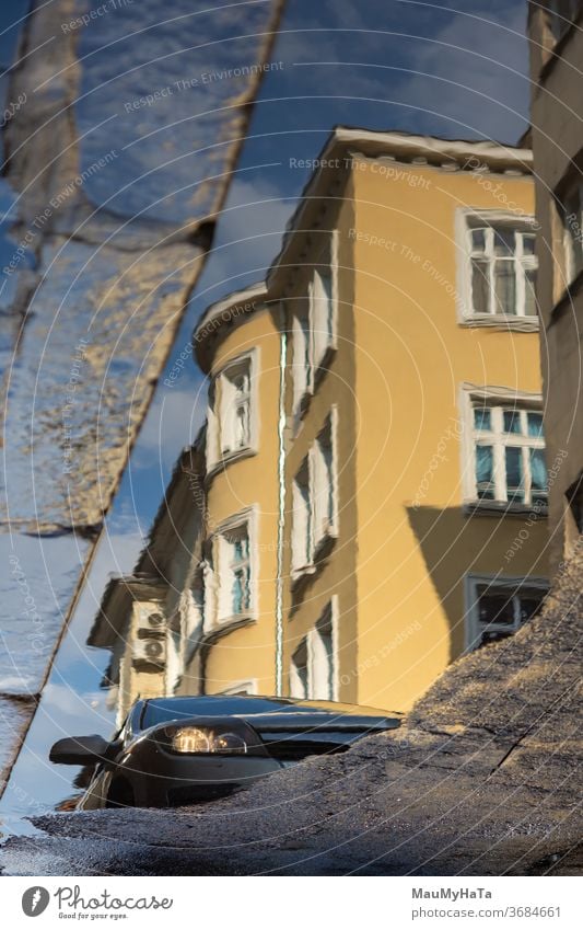 city puddle with reflection building sun car street season summer infrastructure Traffic infrastructure Water Reflection Exterior shot Rain Asphalt Colour photo