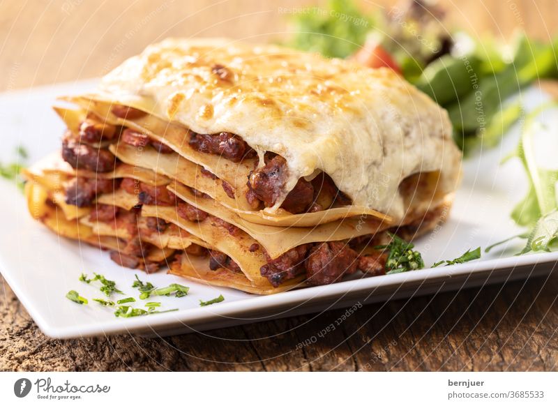 Close-up of a portion of lasagne Lasagne Rustic Tasty nobody homemade Delicious Crockery Mozzarella bechamel Chop Bolognaise Meat Nutrition Mediterranean Meal