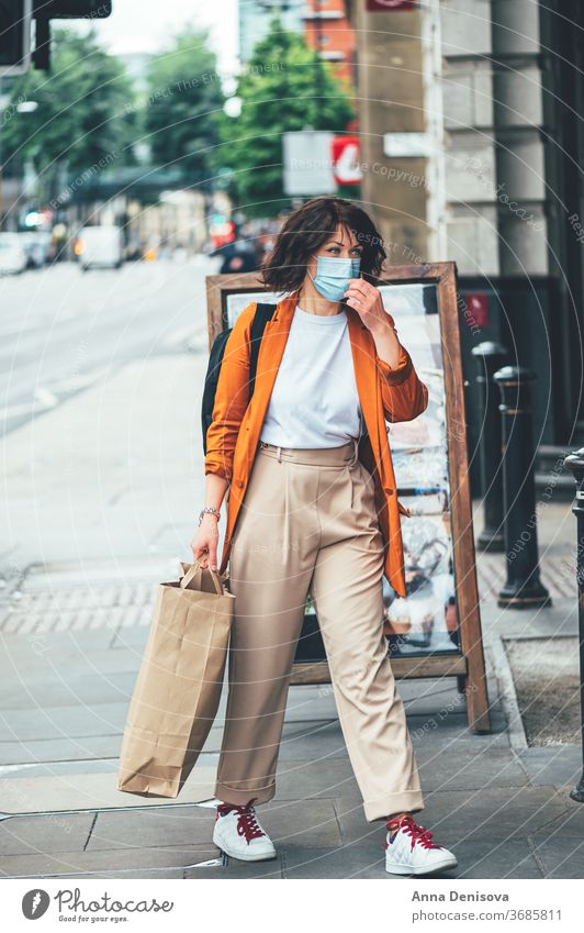 Mum and daughter in face mask are shopping uk new normal manchester england girl covering protection shops display windows lockdown empty city urban people