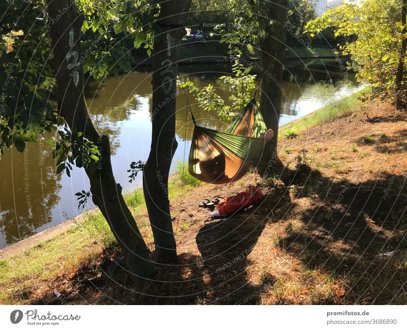 Relax in the evening in the hammock by the water. Photo: Alexander Hauk free time vacation Tourism Hammock Water bank huts Nature Exterior shot Sunlight Evening