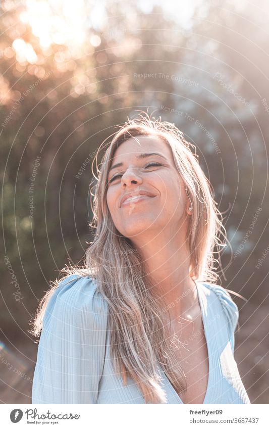 Portrait of a young and attractive caucasian woman near a forest portrait 20s road exterior outdoors lifestyle blonde desaturated retro copy space countryside