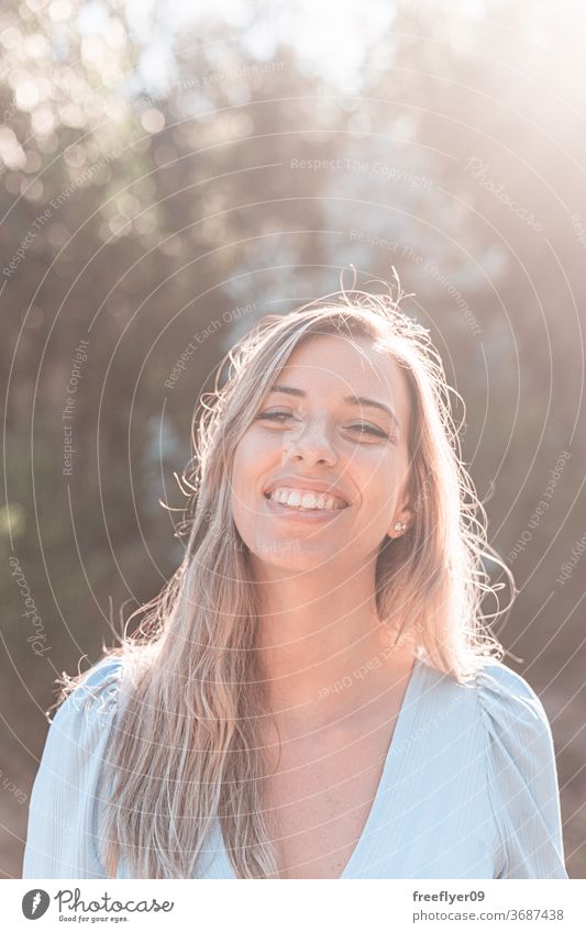 Portrait of a young and attractive caucasian woman near a forest portrait 20s road exterior outdoors lifestyle blonde desaturated retro copy space countryside