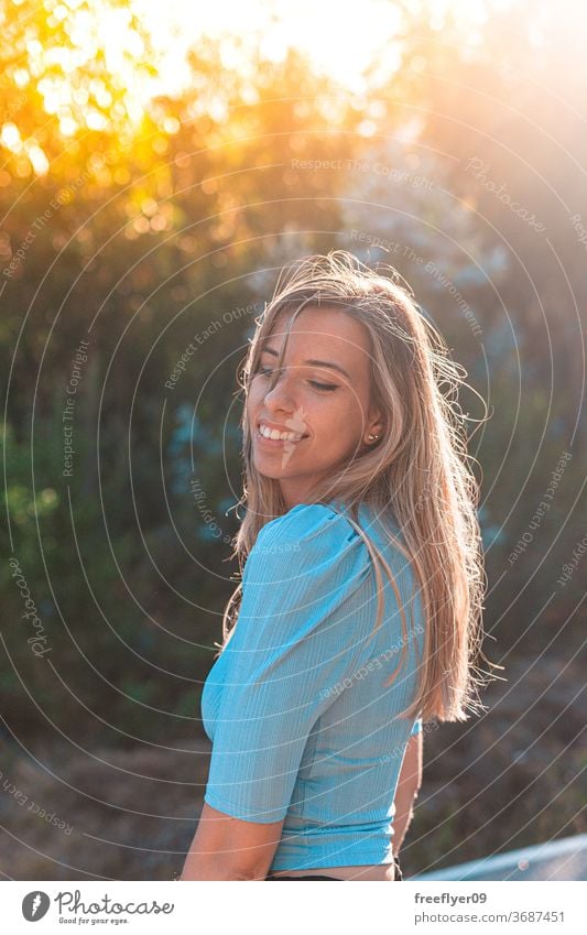 Portrait of a young and attractive caucasian woman near a forest portrait 20s road exterior outdoors lifestyle blonde desaturated retro copy space countryside